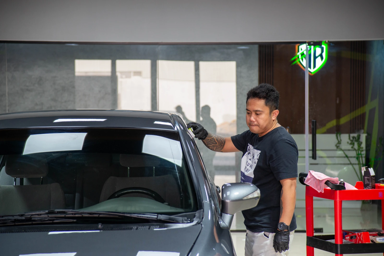 Honda Civic with ceramic coating being applied, with Meraki Cars logo visible in the background