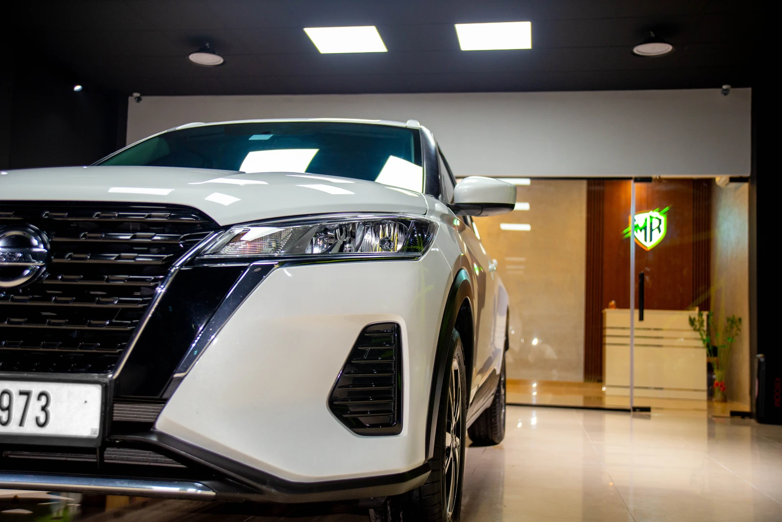 Shining Nissan Kicks with well-framed shot and Meraki Cars Decoration logo in the background.