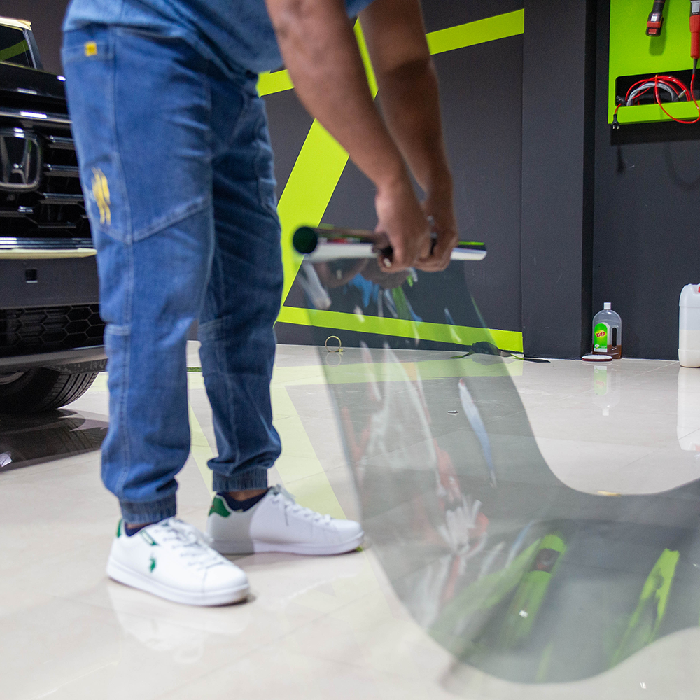 Technician Picking up Premium Ceramic Tint