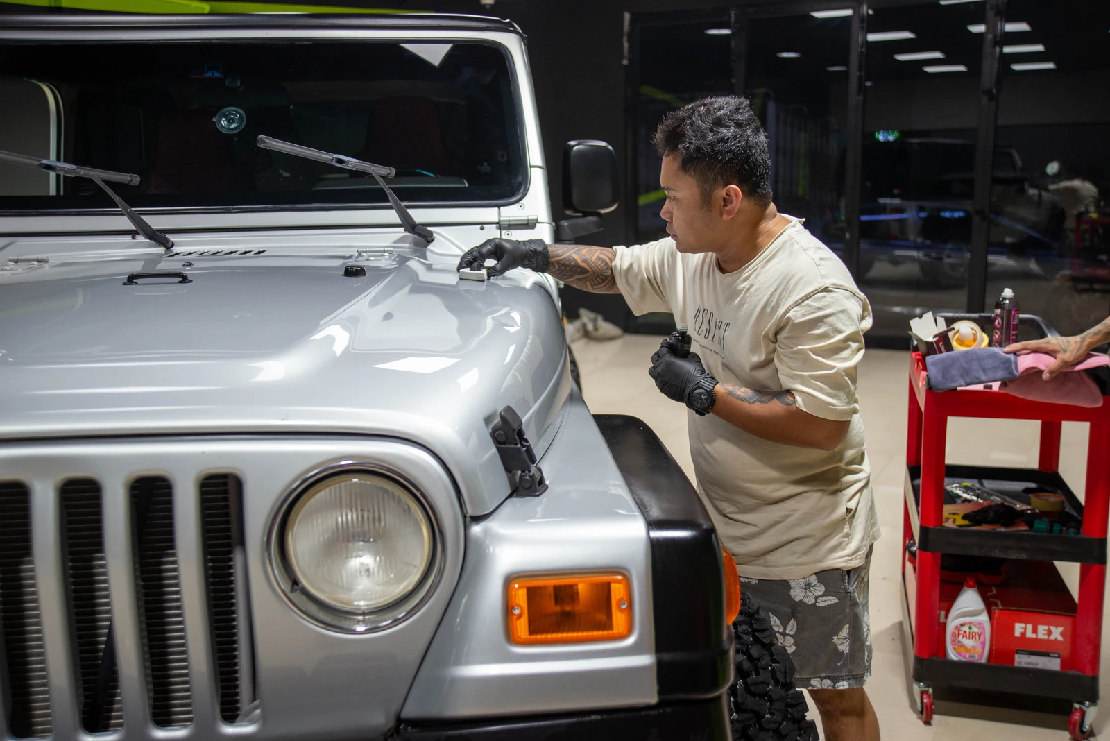 Jeep Wrangler with ceramic coating being applied by Meraki Cars detailing expert Vincent Villacastin.